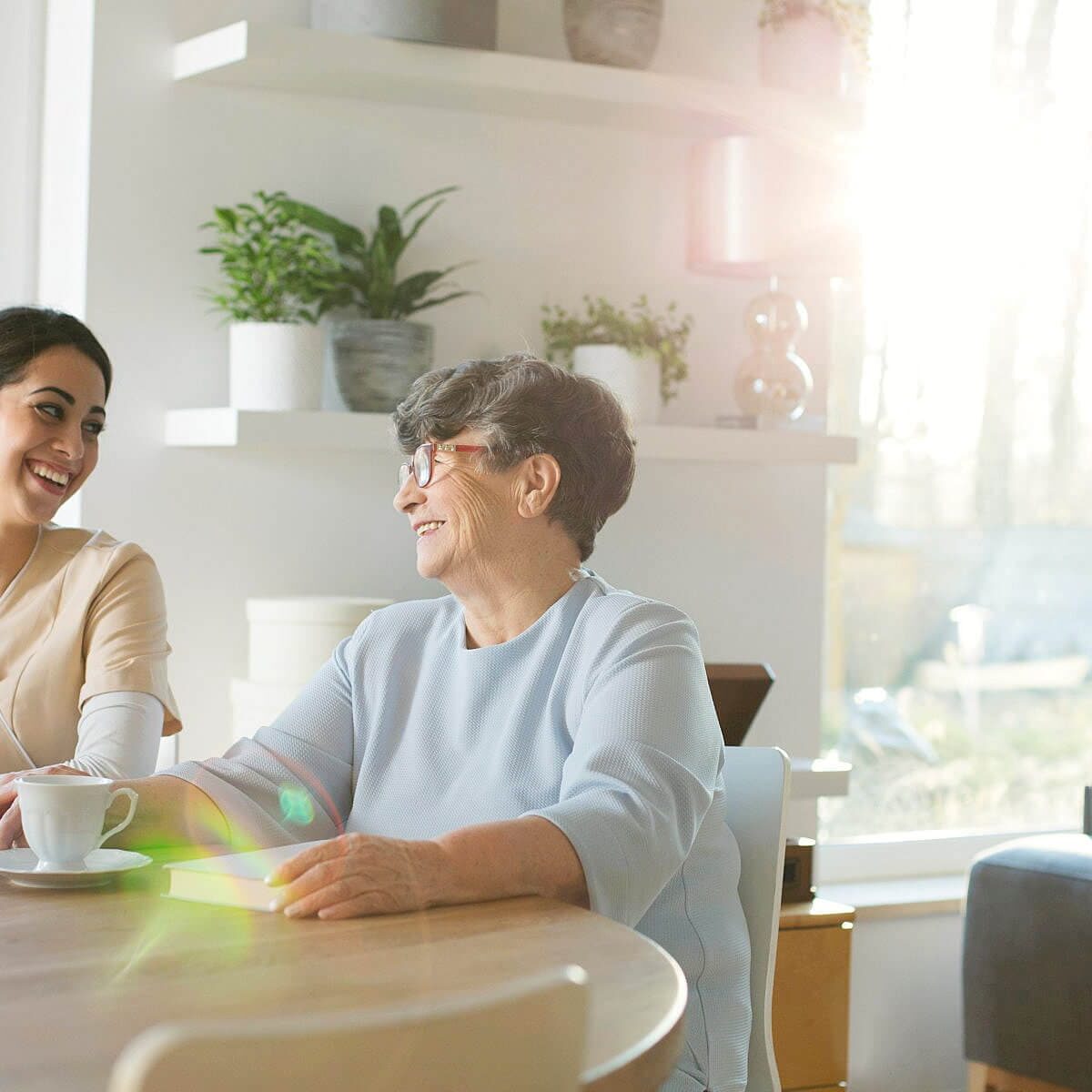 Home 7 Happy senior couple communicating while having coffee in the morning.
